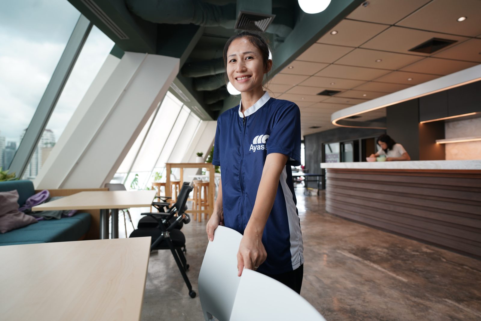 An Ayasan cleaner preparing a meeting area in an office
